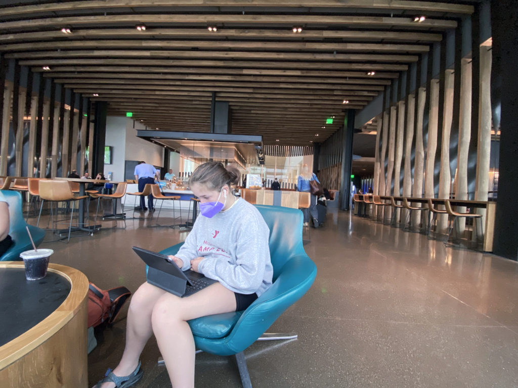 Daughter using iPad in the Alaska Air lounge