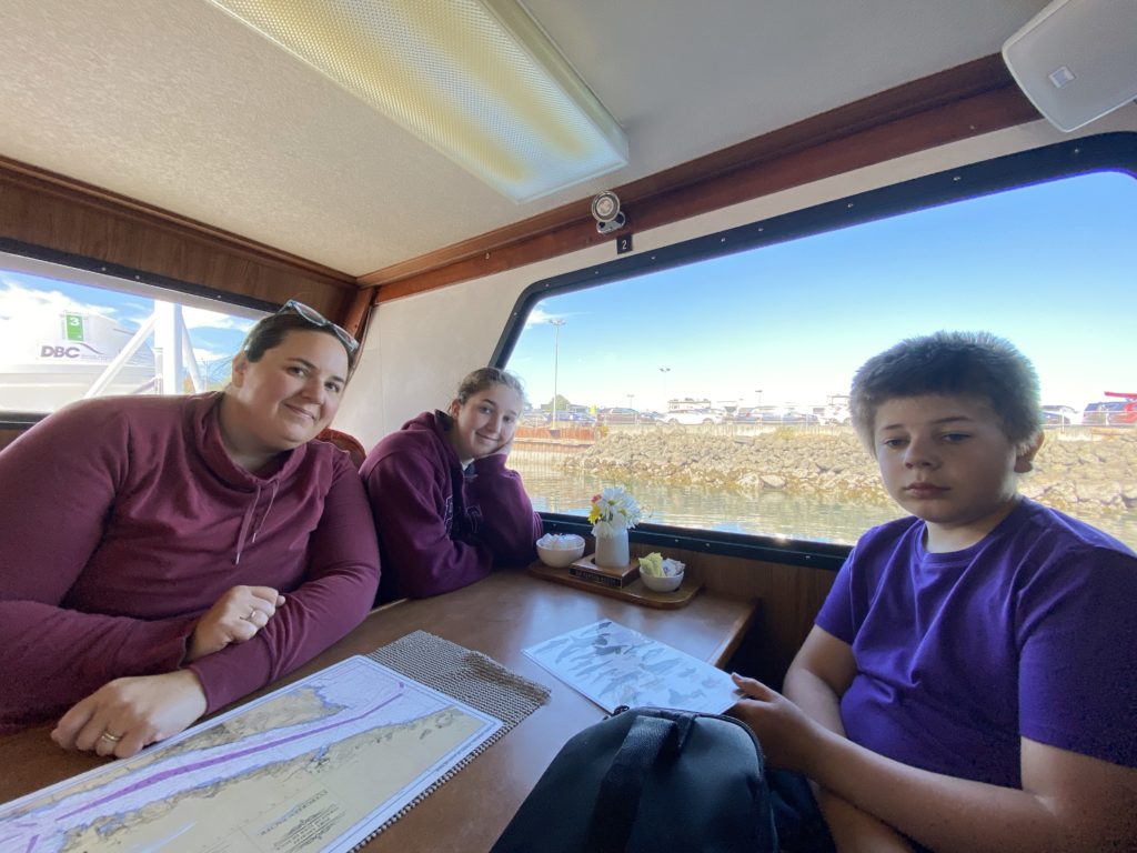 Family posing on a boat