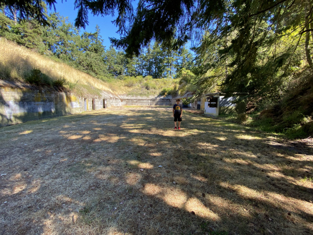 The boy posing in bunker areas of Fort Worden