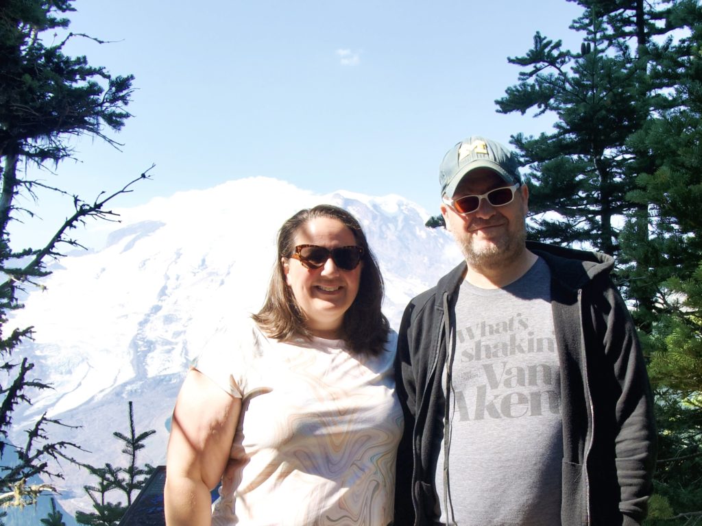 Kate and Mark posing at Mount Rainier overlook at Sunrise