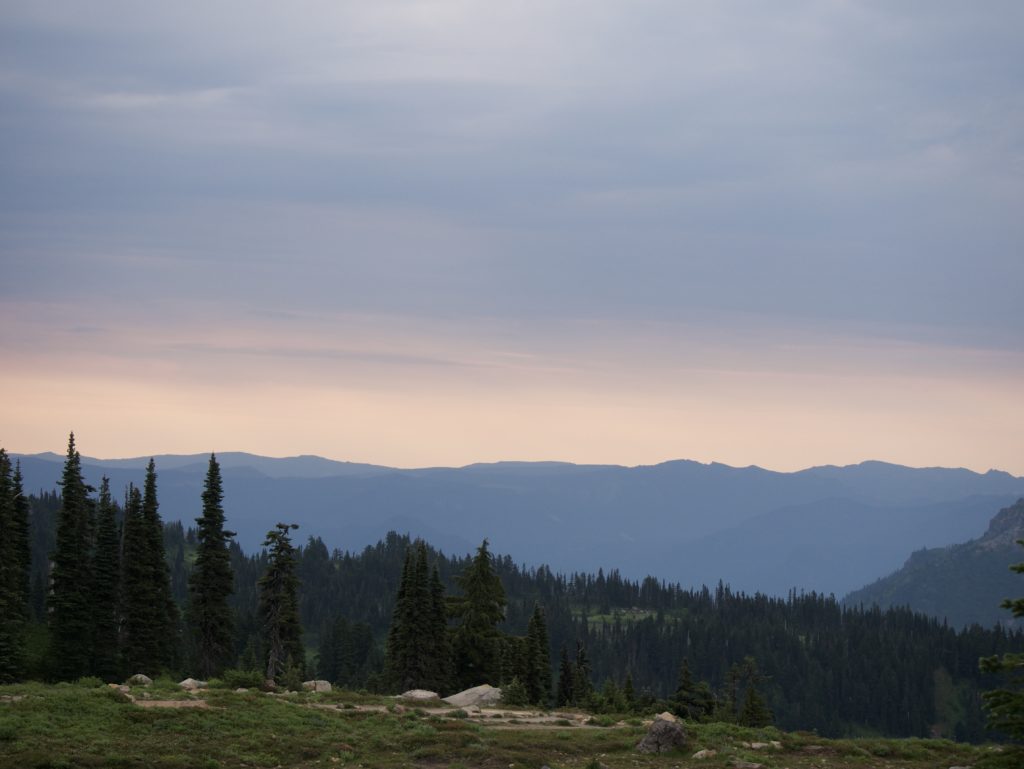 Glowing sky view on Mount Rainier towards the east with mountain ridges in the distance