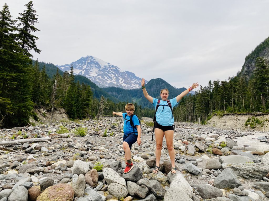 My kids posing in the Nisqually River basin with Mount Rainier in the distance