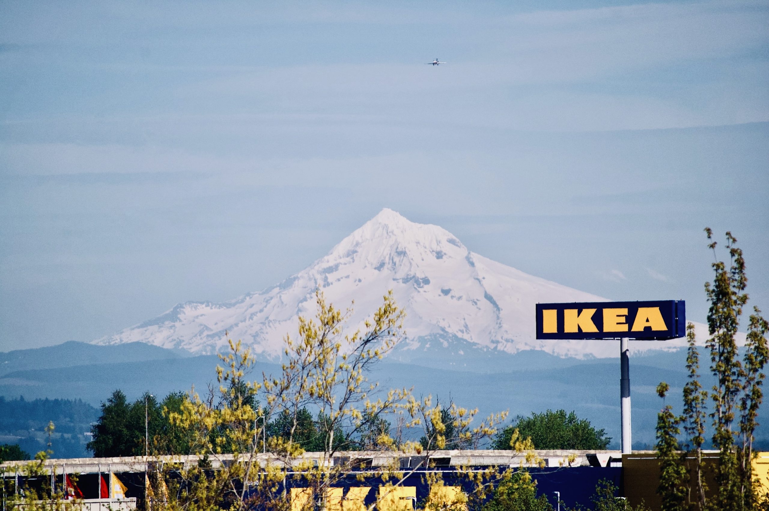 Mt. Hood as seen from Aloft hotel by PDX airport with Ikea sign and airplane on approach to land