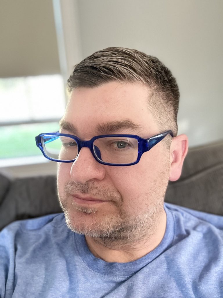 Photo of my fresh haircut and wearing blue framed glasses